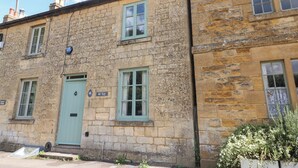 A stone building with numbered doors indicating separate units. - Red Fawn Cottage (Moreton-in-Marsh)