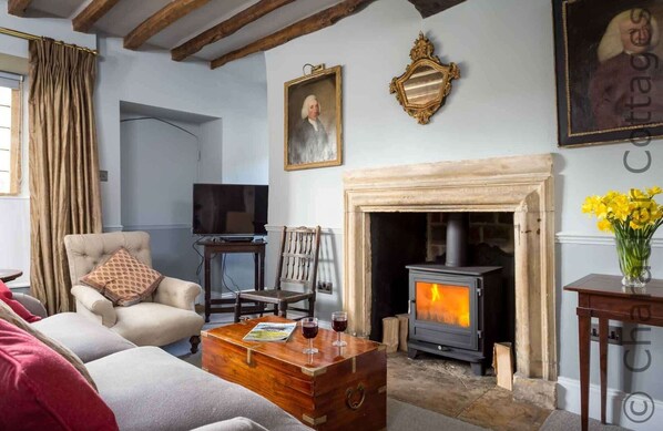 A cozy living room with a fireplace, a television, and comfortable seating.