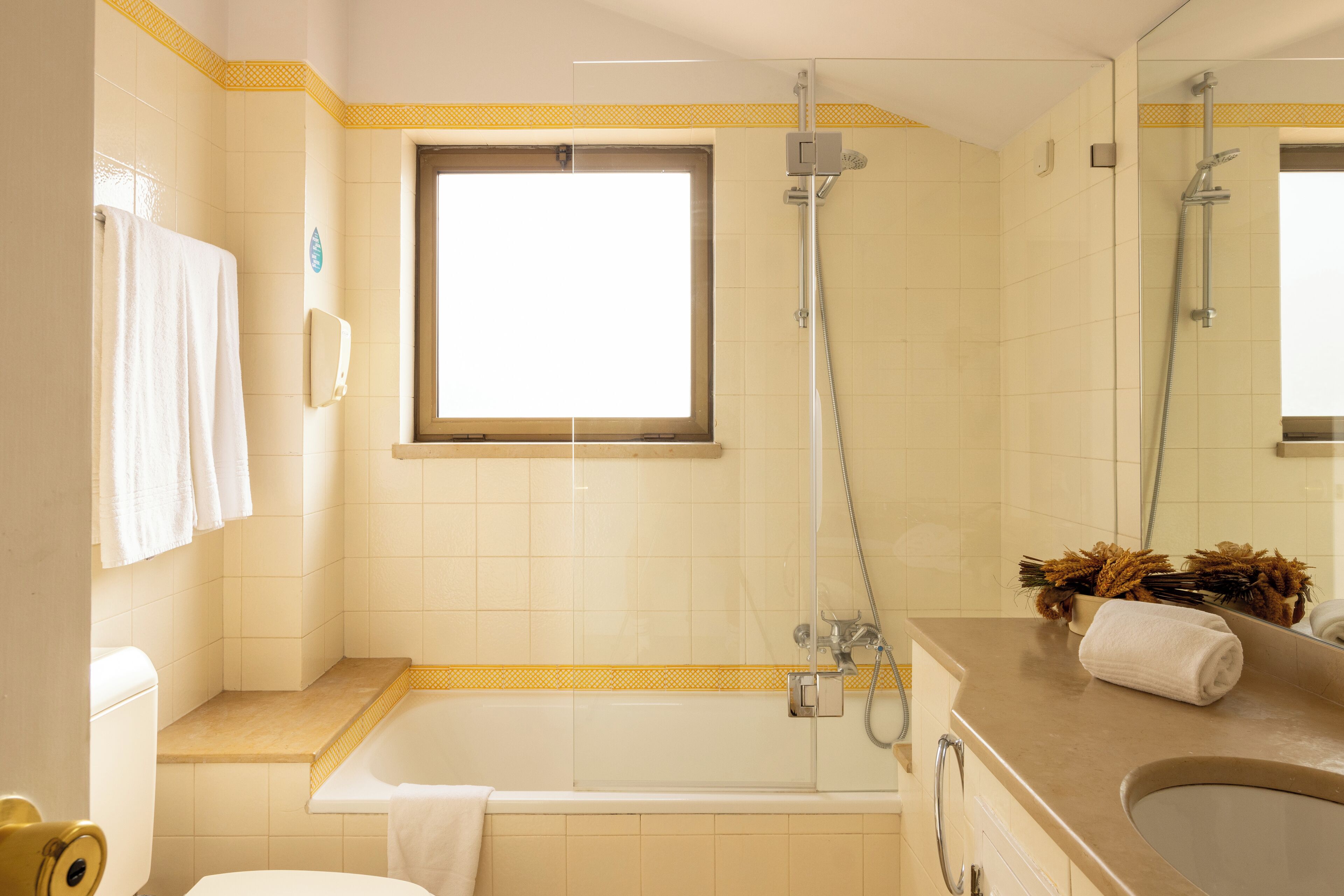 A bathroom with a bathtub, a shower, a toilet, and a sink.