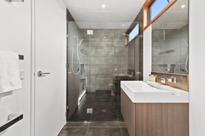 Bathtub, hair dryer, towels, shampoo