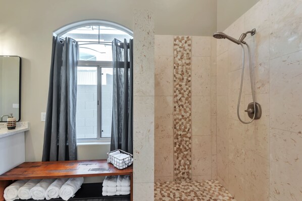 A bathroom with a shower, a window with curtains, and a shelf with towels. - FANTASTIC Scottsdale location! Close to Waste Management Open, and Westworld!! (Scottsdale)