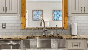 A kitchen with a granite countertop, stainless steel sink, and wooden cabinets. - Much to love Guest favorite Evergreen Hideaway waterfront home w/ dock. Pets ok (Gainesville)