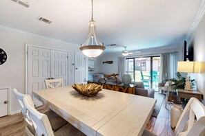 Enjoy meals in this stylish dining area with a large table, comfortable seating, and a unique centerpiece.