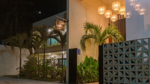 A modern building with a sign reading "MAYANAH" and a decorative light fixture above the entrance. - Mayanah Condohotel Bacalar (Bacalar)