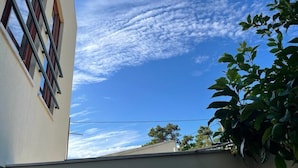 A building with a clear sky and some clouds.