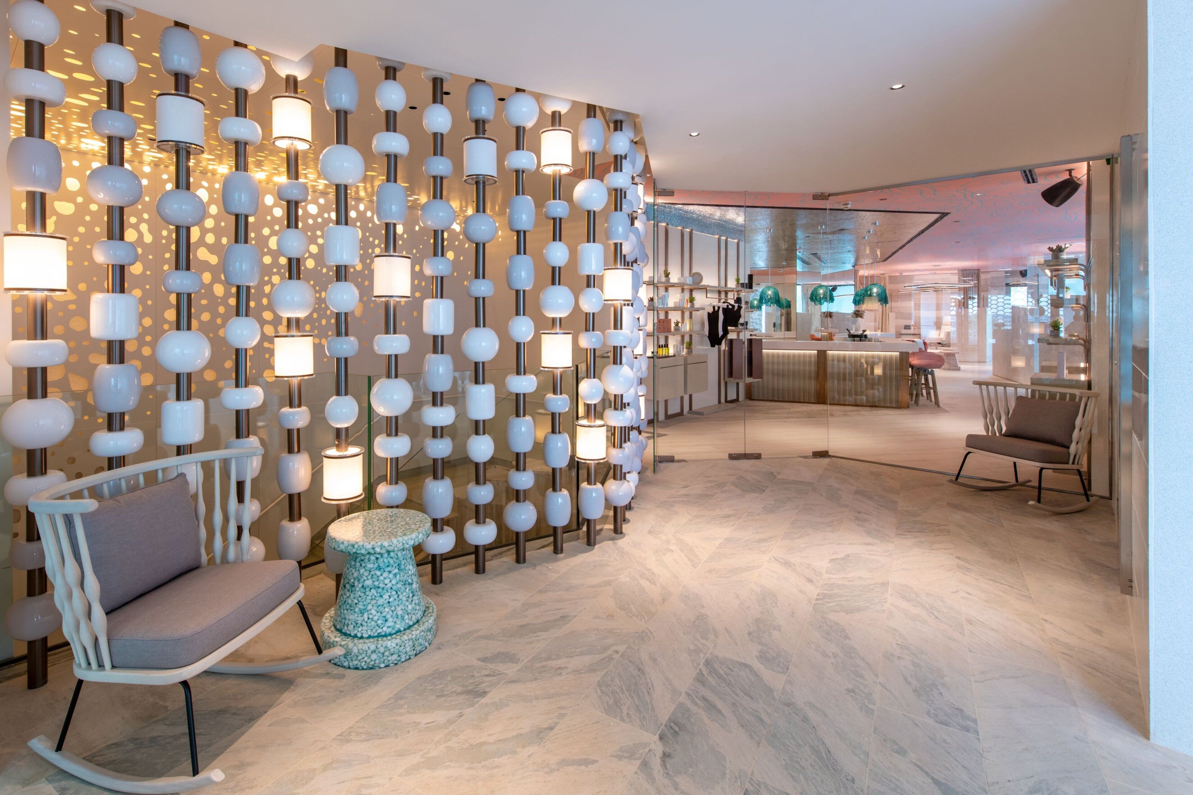 A modern interior with a unique wall design, a seating area, and a visible bar.