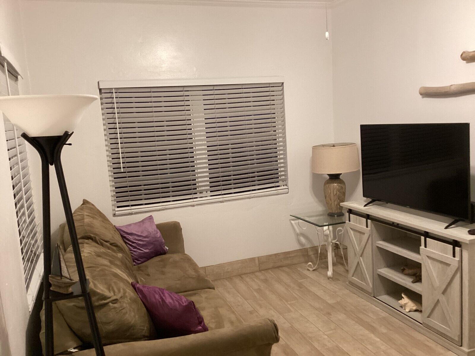 View of the conversational seating area in the living room; see TV stand nearby.