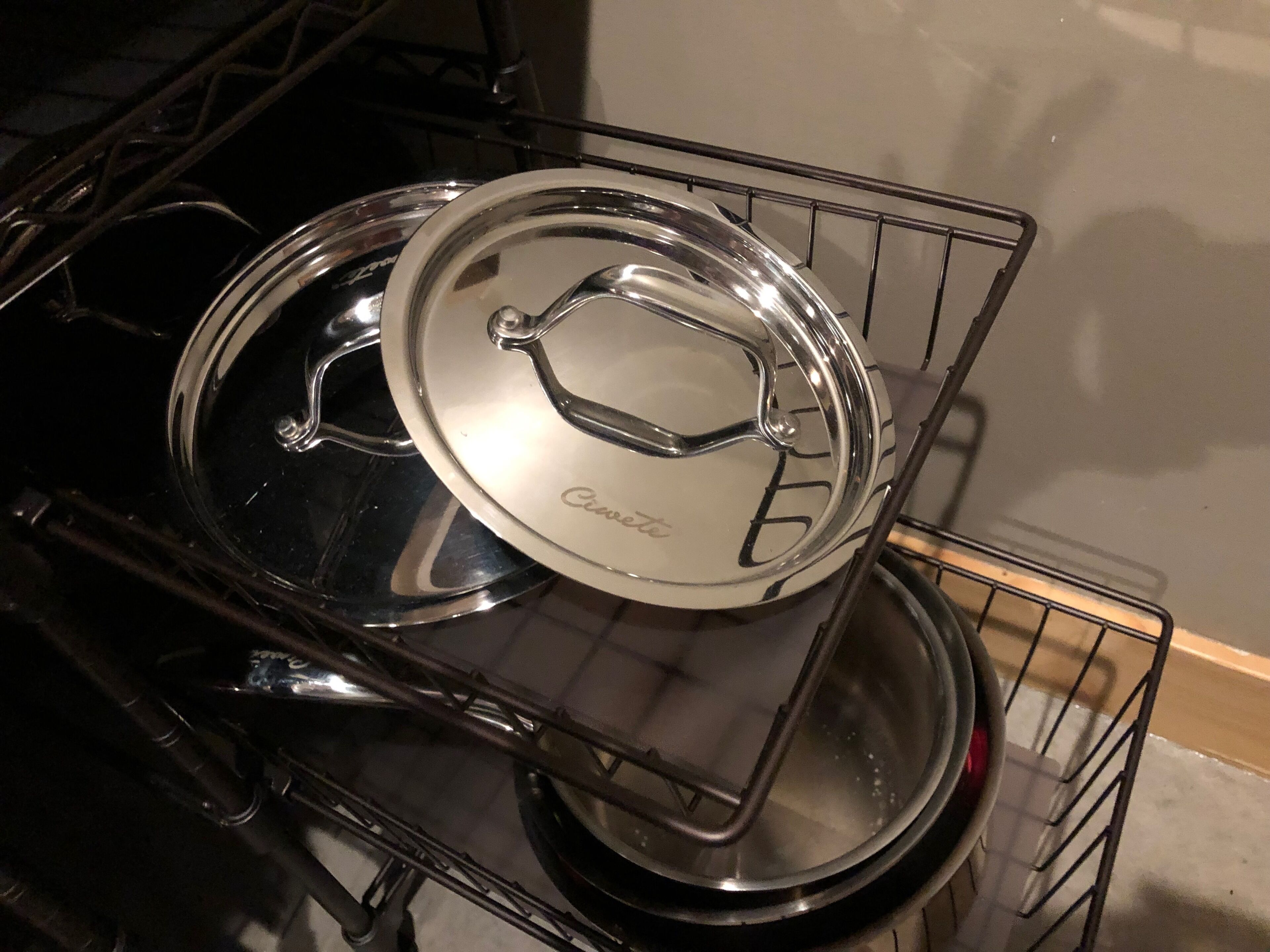 Una cocina con una olla de acero inoxidable sobre una rejilla.