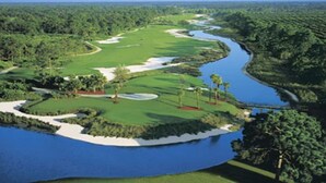 A golf course with a water body, sand bunkers, and lush greenery. - 2 Room PGA Village Golf Villa Suite by Clubhouse (Port Saint Lucie)