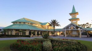 A large building with a green roof and a clock tower. - 2 Room PGA Village Golf Villa Suite by Clubhouse (Port Saint Lucie)