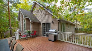 A wooden deck with a grill and outdoor seating. - Former Lottery Home Near Private Beach & River (Grand Bend)