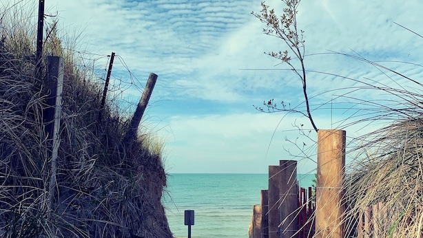 A beach path leading to the sea with a wooden fence and a signpost. - Former Lottery Home Near Private Beach & River (Grand Bend)