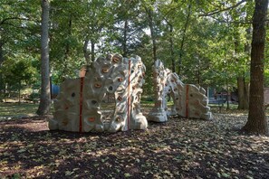 A sculpture installation in a park with trees and benches in the background. - Wilderness Club™ at Big Cedar® - 1 Bedroom Lodge (Ridgedale)