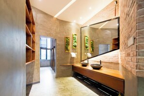 A modern bathroom with a large mirror, wooden vanity, and a view of the hallway. - Jinglan LOFT Boutique Hotel (Baishamen Hainan University) (Haikou)