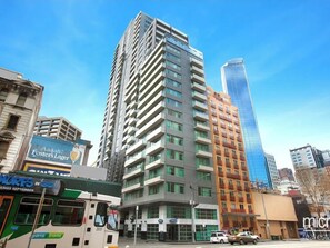 A high-rise building with multiple floors, large windows, and a modern architectural design.