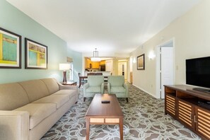 Relax in a comfortable space with a sofa, armchair, and flat-screen TV.