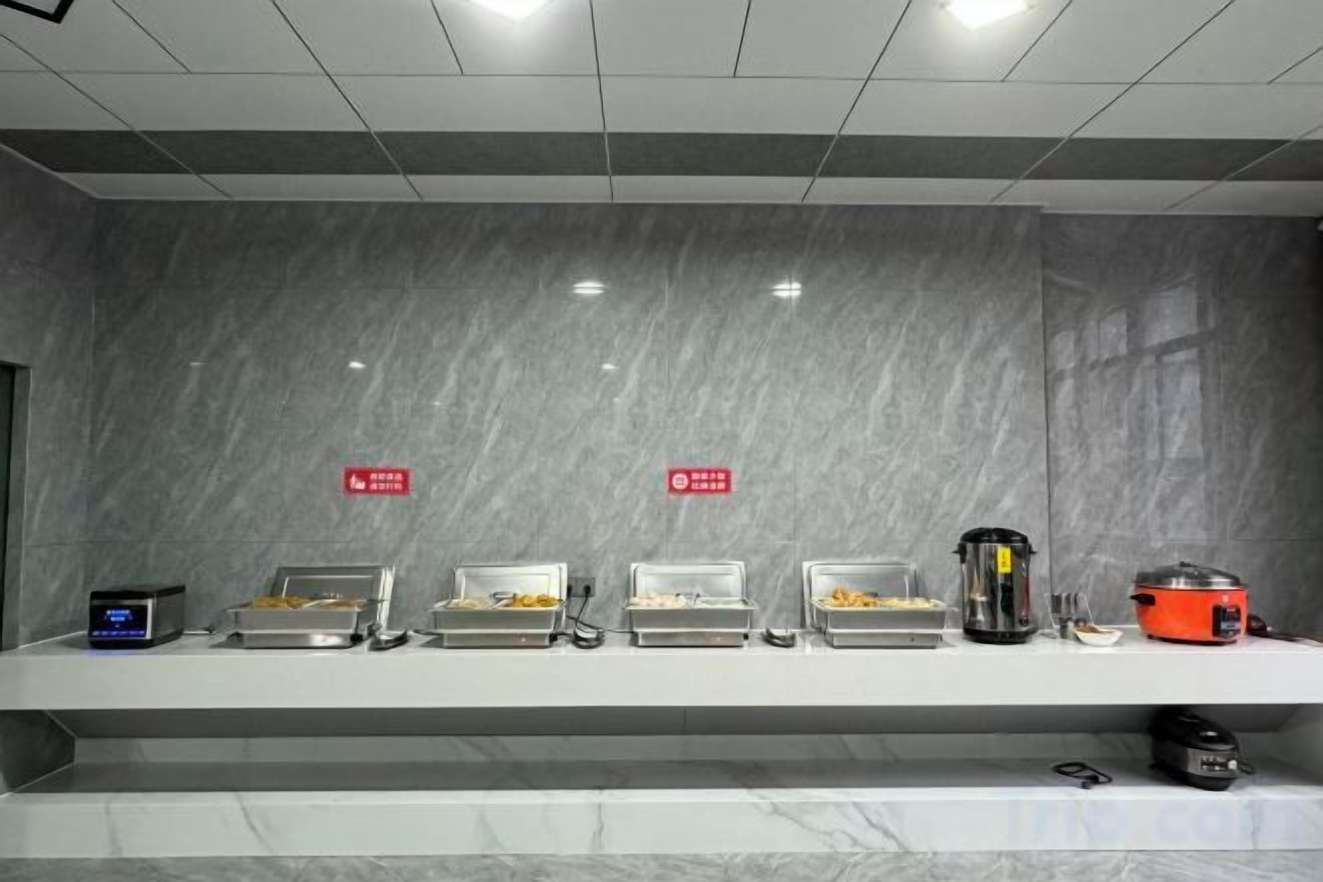 A buffet setup with multiple food stations and a digital scale.