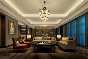 A spacious living room with a chandelier, sofas, and a coffee table. - Hui Chang Hotel (Huichang)
