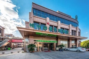 A hotel with a modern facade, a prominent entrance, and a visible staircase leading to the entrance. - GreenTree Hotel (Nantong University International Exhibition Center) (Nantong)