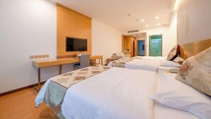 A hotel room with two beds, a desk, a television, and a bathroom visible through an open door. - GreenTree Hotel (Nantong University International Exhibition Center) (Nantong)