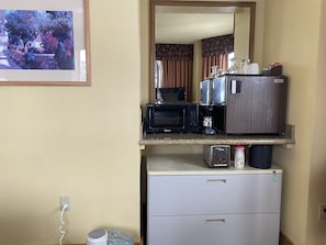 Enjoy cooking and dining in this well-equipped kitchenette with a microwave, coffee maker, and refrigerator.