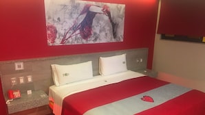 A hotel room with a bed, a red and white bedspread, a red telephone, and a wall-mounted artwork. - Hotel Nayarit - Solo Adultos (Mexico City)