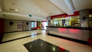 A hotel reception area with a counter, vending machines, and a red sign. - Hotel Nayarit - Solo Adultos (Mexico City)