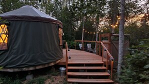 A yurt with a wooden deck and a ladder leading up to the entrance. - Hideaway Glamping Yurt  (Bellingham)