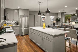 A modern kitchen with grey cabinets, stainless steel appliances, pendant lighting, and a central island. - Beautifully Decorated, Private Hot Tub! Pony Soldi (Sedona)