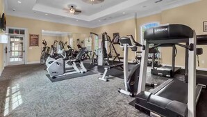 A gym with various exercise equipment, a Landice treadmill, and a mirrored wall. - 1361 Tuscana (Davenport)