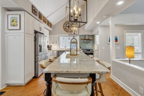 Enjoy cooking in this well-equipped kitchen with a central island, oven, and gas range.