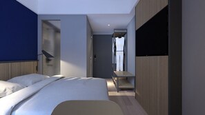 A modern hotel room with a bed, a desk, and a TV. - LeGreen Suite Sudirman (Jakarta)