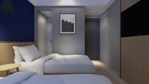 A modern bedroom with a bed, bedside table, and a framed artwork on the wall. - LeGreen Suite Sudirman (Jakarta)