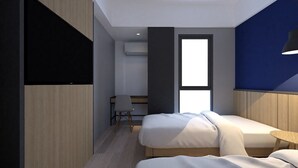 A modern hotel room with a bed, a desk, and a chair. - LeGreen Suite Sudirman (Jakarta)