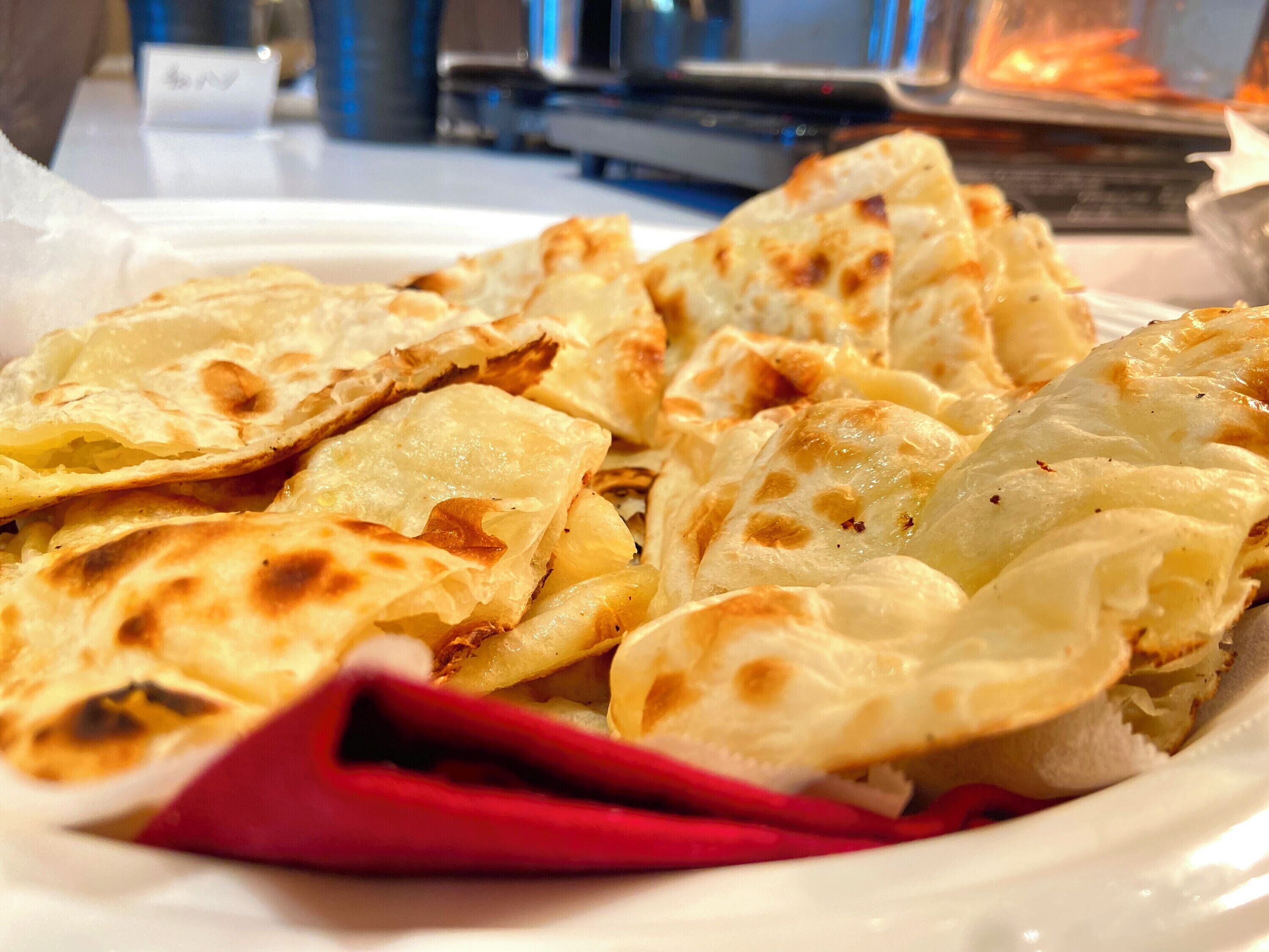A plate of flatbreads with a red napkin underneath.