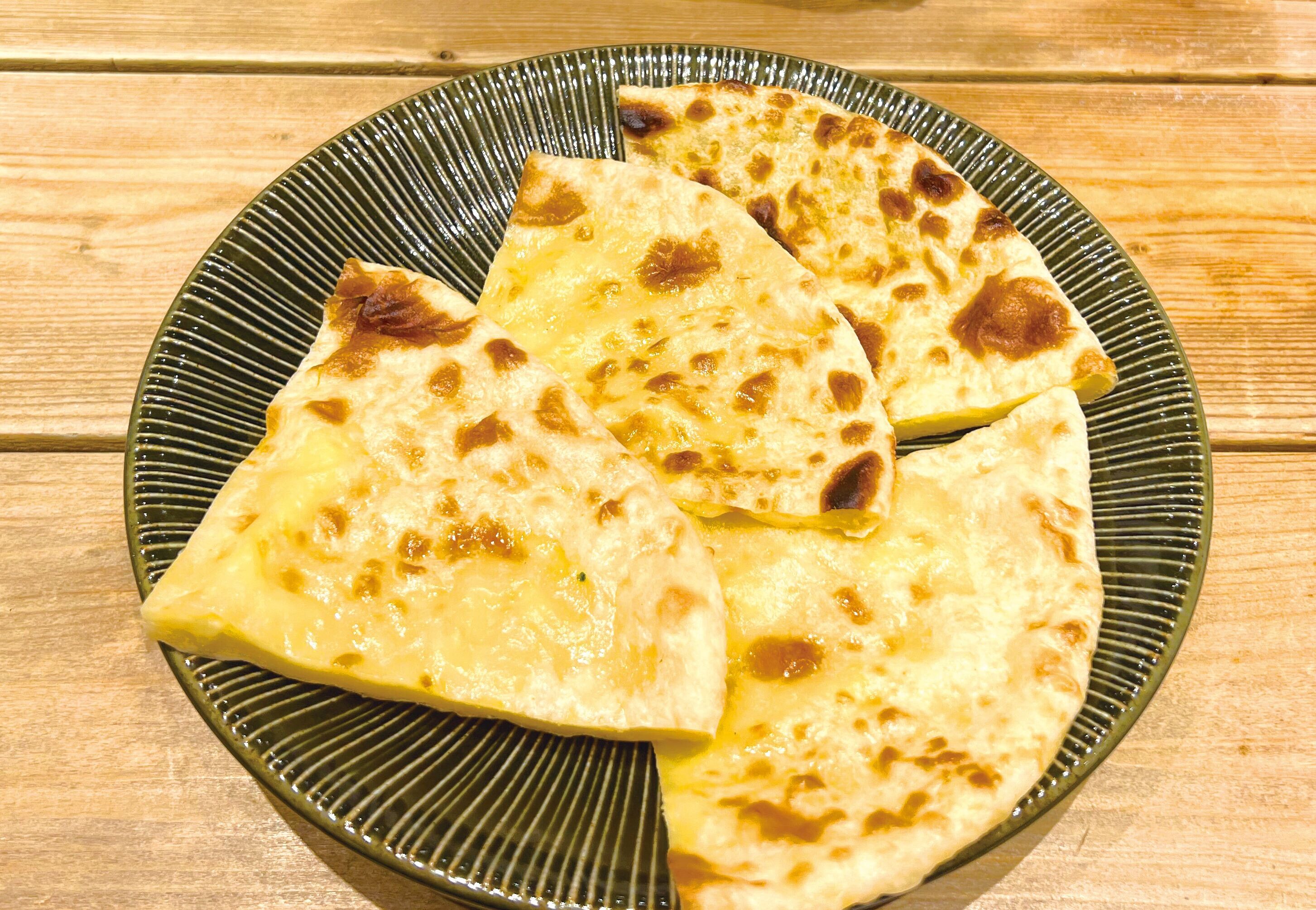 A plate of flatbreads on a textured ceramic plate.