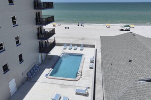A rooftop pool with a view of the beach and ocean. - Wraparound Corner Balcony. Heated Pool. Direct Beachfront. Outstanding Views. (Madeira Beach)