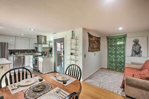 A modern kitchen with white cabinets, a stainless steel range hood, and a built-in dishwasher. - Seattle Area Getaway ~ 5 Mi to Puget Sound! (Mountlake Terrace)