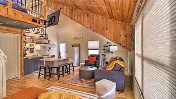 A cozy loft-style living space with a kitchen, dining area, and seating area.
