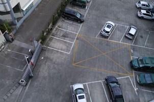 Vista aérea de un estacionamiento con varios automóviles y una pasarela para peatones.