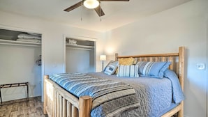 A bedroom with a wooden bed frame, a quilted bedspread, and a ceiling fan. - Relaxing Rural Harrison Home - 11 Mi to Town (Harrison)