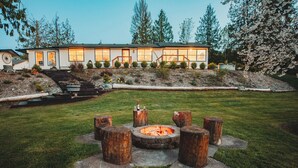 A modern house with a fire pit in the yard. - Charming Hilltop Getaway - Valley and Water Views (Sequim)