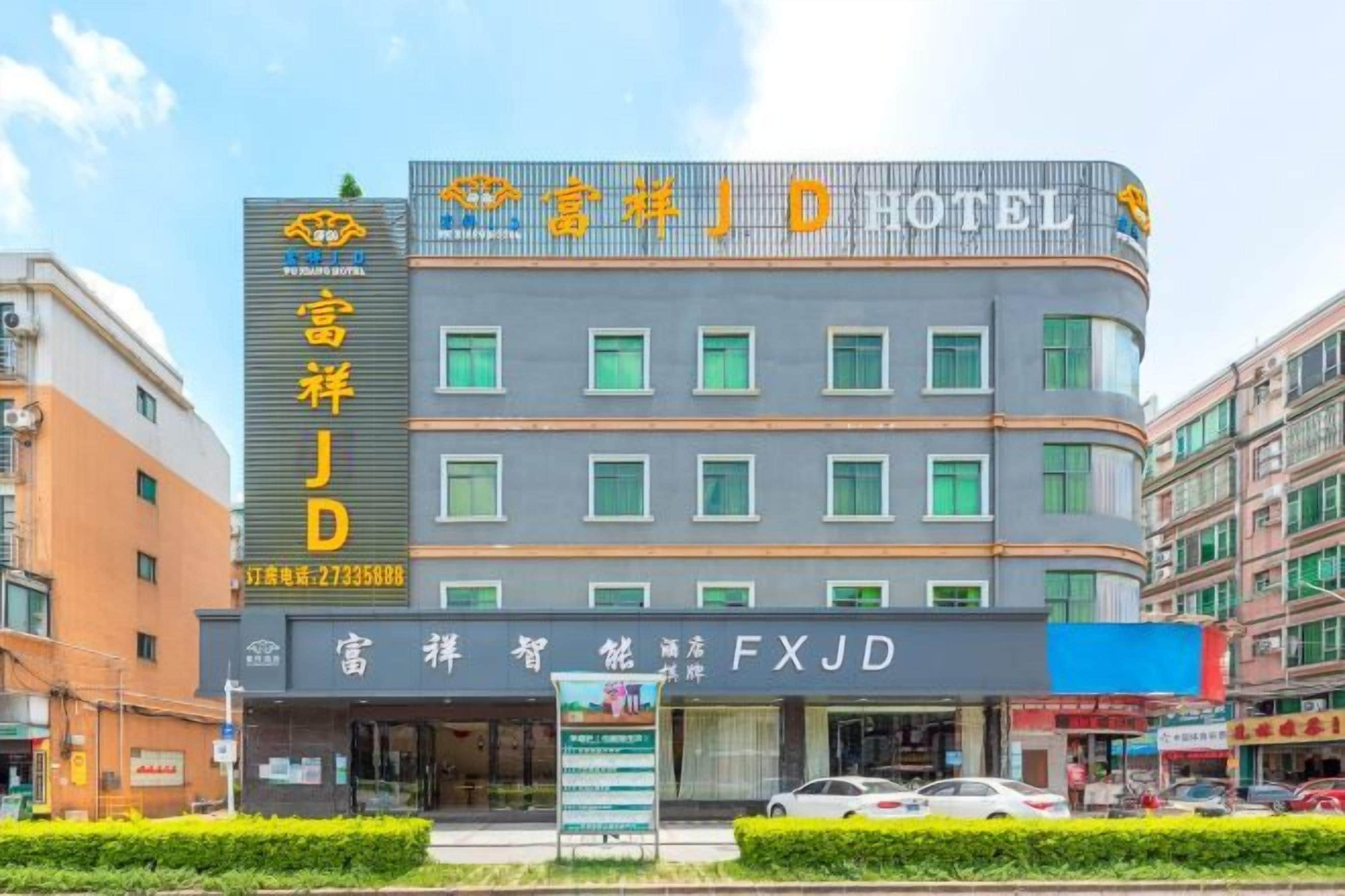 A hotel with a modern facade, multiple floors, and a prominent sign.