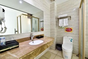 A modern bathroom with a marble sink, a large mirror, a glass shower enclosure, and a toilet. - Fuxiang Hotel (Foshan Shunde Lunjiao Branch) (Foshan)