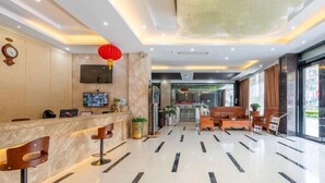 A modern hotel lobby with a reception desk, seating area, and a large chandelier. - Fuxiang Hotel (Foshan Shunde Lunjiao Branch) (Foshan)