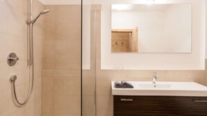 A modern bathroom with a shower, sink, and mirror. - Unwind - relax - seek peace - enjoy - Merano is my holiday destination (Meran)