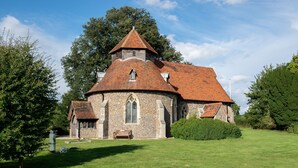 A stone church with a red-tiled roof, a wooden bell tower, and a grassy lawn in front. - The Stables -  A rural, romantic retreat in a particularly pretty countryside setting close to Castl (Great Maplestead)