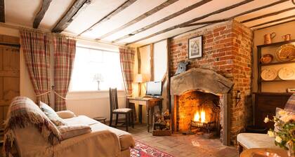 A romantic little Flax Workers Cottage with a beautiful open fire and an enclosed garden which leads