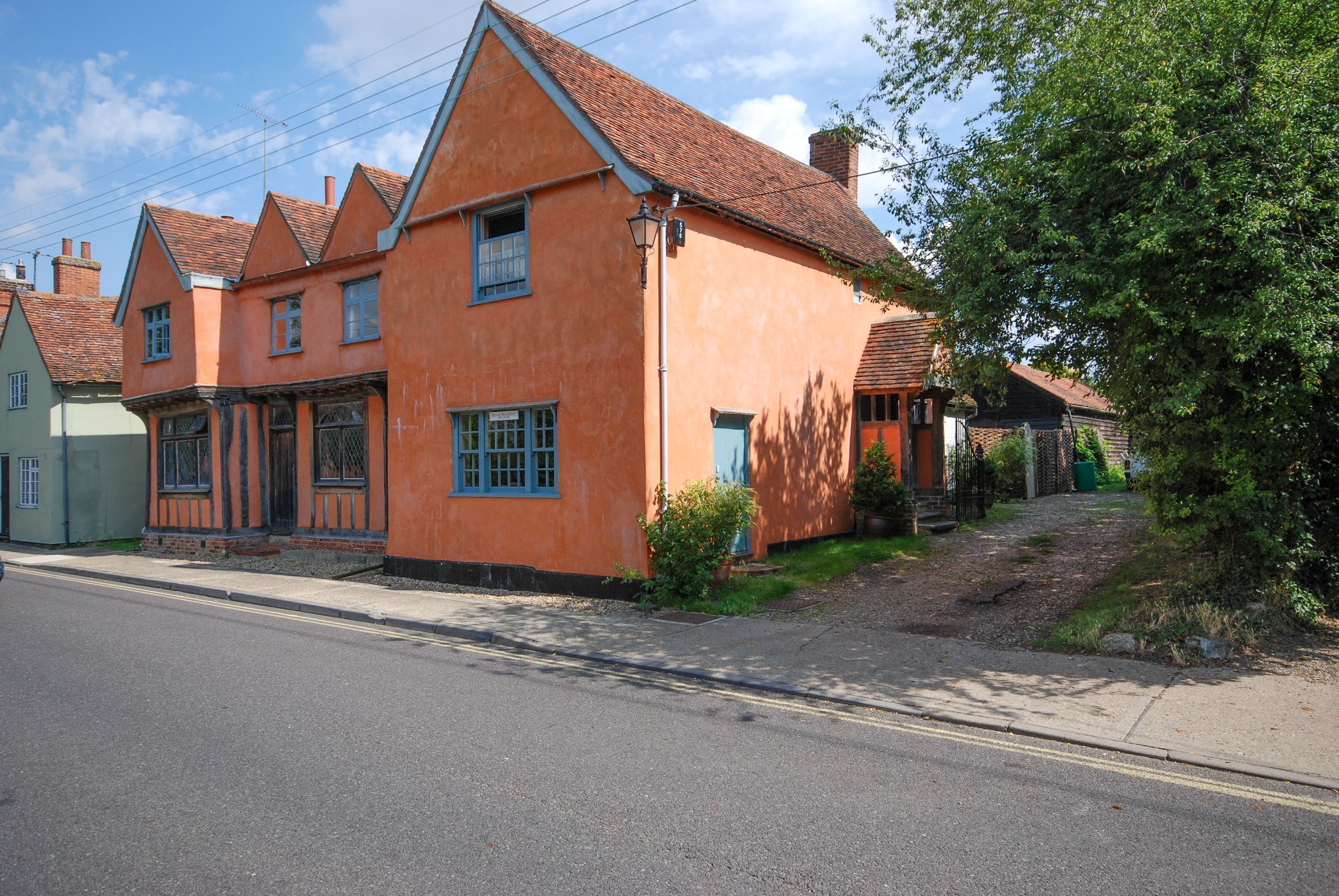 A row of traditional houses with pitched roofs and a narrow street.