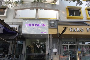Ein Hotel namens 'Bhooshan Hotel' mit einem Schild davor.